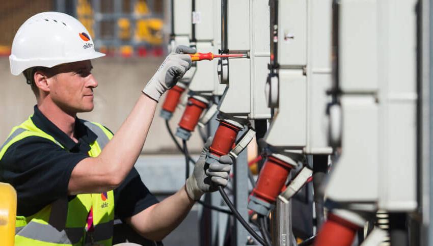 Man in hard hat fixing equipment